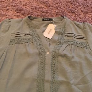 Sage colored light blouse.